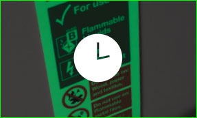 Glow in the dark fire equipment sign with a clock icon